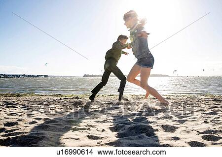 Twin brother and sister playing on beach View Large Photo Image Picture - Twin brother and sister playing on beach. Fotosearch