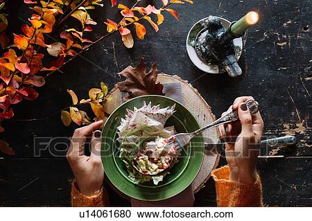 Woman eating fresh salad at vintage table, overhead view of hands View Large Photo Image Stock Image - Woman eating fresh salad at vintage table, overhead view of hands. Fotosearch