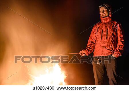 Stock Image - Woman grilling on barbecue, Nexen Beach, Squamish, Canada. Fotosearch
