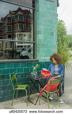 Woman using digital tablet at pavement cafe, London, UK View Large Photo Image Stock Image - Woman using digital tablet at pavement cafe, London, UK. Fotosearch