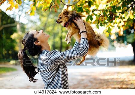 Woman with pet dog in park View Large Photo Image Picture - Woman with pet dog in park. Fotosearch