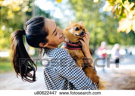 Woman with pet dog in park View Large Photo Image Stock Photo - Woman with pet dog in park. Fotosearch
