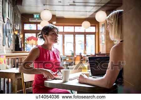 Women brainstorming business ideas in restaurant View Large Photo Image Stock Photograph - Women brainstorming business ideas in restaurant. Fotosearch