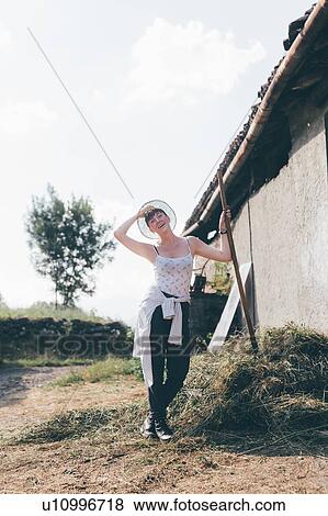 Young female agricultural worker with pitchfork, full length portrait View Large Photo Image Stock Photo - Young female agricultural worker with pitchfork, full length portrait. Fotosearch