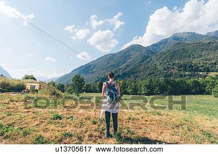 Young female hiker looking towards mountains, rear view, Primaluna, Trentino-Alto Adige, Italy View Large Photo Image Stock Photo - Young female hiker looking towards mountains, rear view, Primaluna, Trentino-Alto Adige, Italy. Fotosearch