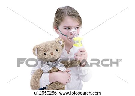 Stock Photograph - Young girl using nebuliser holding teddy bear.. Fotosearch