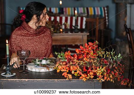 Young woman looking over her shoulder from dinner table View Large Photo Image Stock Photo - Young woman looking over her shoulder from dinner table. Fotosearch