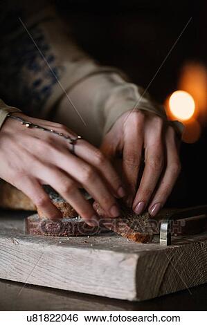 Young woman preparing brown bread on rustic chopping board, close up of hands View Large Photo Image Stock Photograph - Young woman preparing brown bread on rustic chopping board, close up of hands. Fotosearch