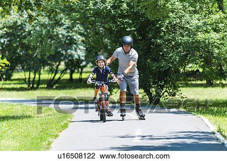 Stock Image - Active senior with his grandson. Fotosearch