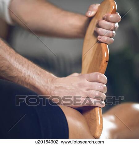 Stock Image - Anti-cellulite maderotherapy massage. Fotosearch