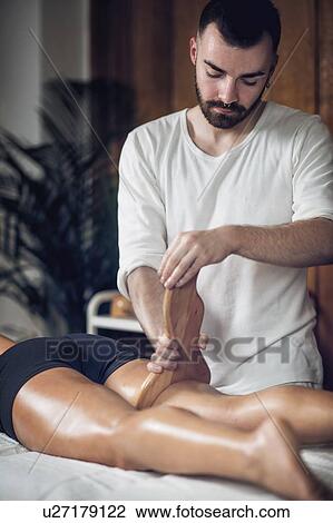 Stock Image - Anti-cellulite maderotherapy massage. Fotosearch