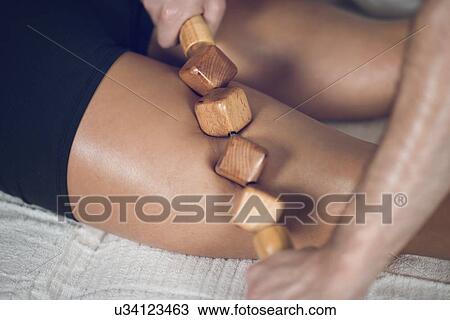 Stock Image - Anti-cellulite maderotherapy massage. Fotosearch