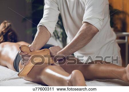 Stock Image - Anti-cellulite maderotherapy massage. Fotosearch