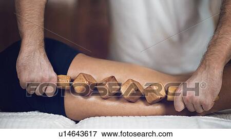 Stock Photo - Anti-cellulite maderotherapy massage. Fotosearch