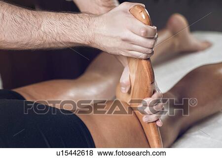 Stock Photo - Anti-cellulite maderotherapy massage. Fotosearch