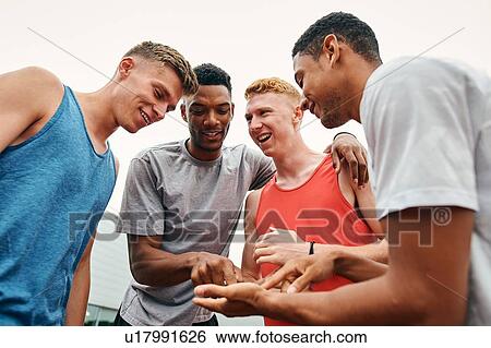 Stock Photograph - Athlete friends enjoying conversation. Fotosearch