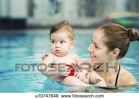 Stock Photo - Baby and mother in swimming pool. Fotosearch