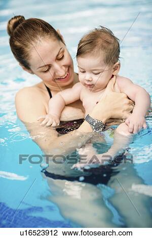 Baby boy with mother in swimming pool View Large Photo Image Stock Image - Baby boy with mother in swimming pool. Fotosearch