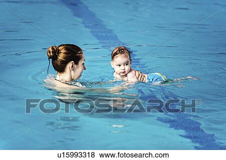 Baby boy with mother in swimming pool View Large Photo Image Stock Photo - Baby boy with mother in swimming pool. Fotosearch