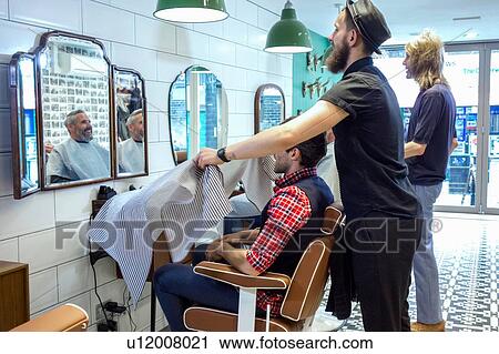 Barbers working in barbershop View Large Photo Image Stock Image - Barbers working in barbershop. Fotosearch