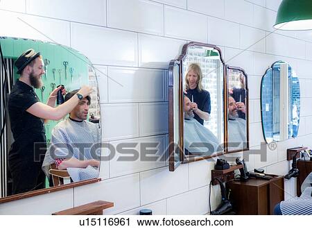 Barbers working in barbershop View Large Photo Image Stock Image - Barbers working in barbershop. Fotosearch