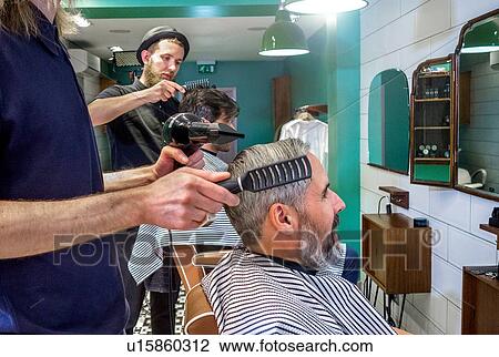 Barbers working in barbershop View Large Photo Image Stock Image - Barbers working in barbershop. Fotosearch