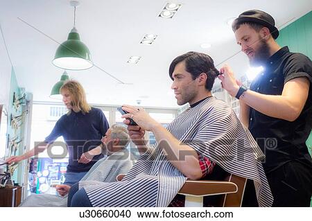 Barbers working in barbershop View Large Photo Image Stock Image - Barbers working in barbershop. Fotosearch