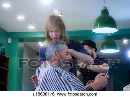 Barbers working in barbershop View Large Photo Image Stock Photograph - Barbers working in barbershop. Fotosearch