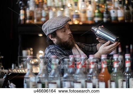 Barman shaking cocktail in traditional Irish public house View Large Photo Image Picture - Barman shaking cocktail in traditional Irish public house. Fotosearch