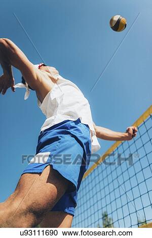 Stock Image - Beach volley player at the net. Fotosearch