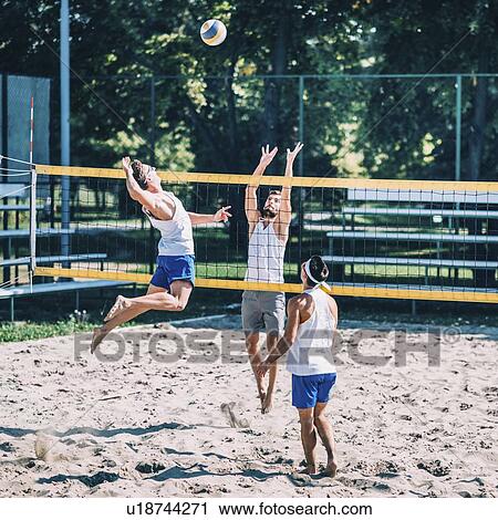 Stock Image - Beach volleyball game. Fotosearch