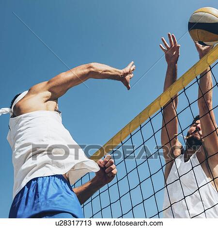 Stock Image - Beach volleyball game. Fotosearch