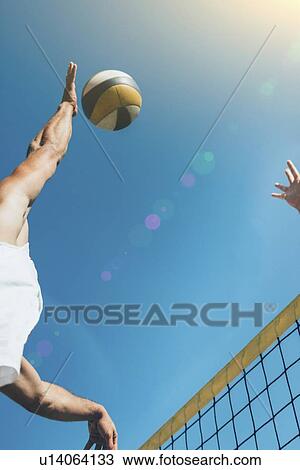 Beach volleyball player about to hit the ball View Large Photo Image Stock Image - Beach volleyball player about to hit the ball. Fotosearch