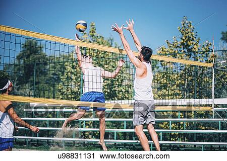 Beach volleyball players at the net View Large Photo Image Stock Image - Beach volleyball players at the net. Fotosearch