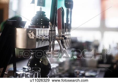 Stock Photo - Beer pumps in traditional Irish public house. Fotosearch