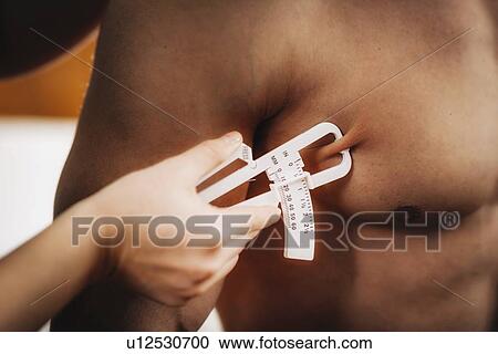 Stock Image - Body fat measurement. Fotosearch