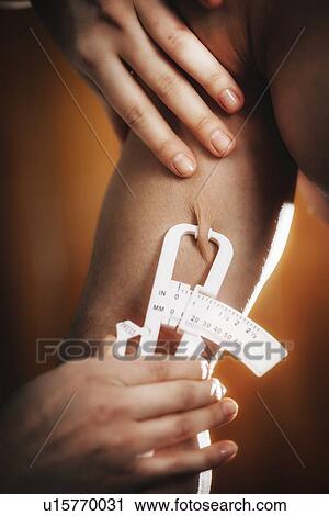 Stock Image - Body fat measurement. Fotosearch
