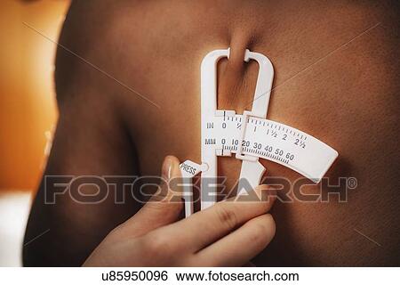 Stock Photograph - Body fat measurement. Fotosearch