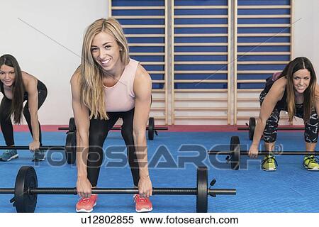 Stock Photography - Body pump fitness class. Fotosearch