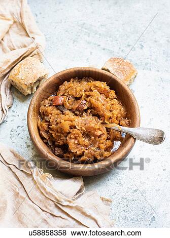 Stock Photo - Bowl of cabbage soup with bread roll, still life, overhead view. Fotosearch