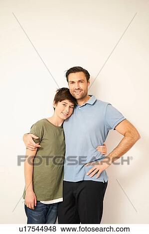 Boy and father with arms around each other, portrait View Large Photo Image Stock Photo - Boy and father with arms around each other, portrait. Fotosearch