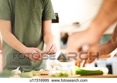 Boy and his father preparing food at kitchen counter, mid section View Large Photo Image Stock Photography - Boy and his father preparing food at kitchen counter, mid section. Fotosearch