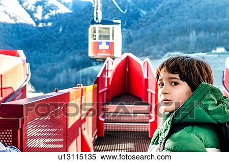 Stock Photography - Boy at cable car station, Piani Resinelli, Lombardy, Italy. Fotosearch