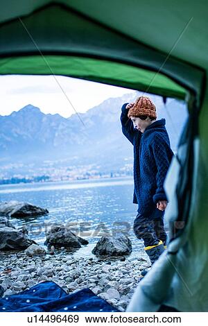 Boy camping on lakeside, view from inside tent, Onno, Lombardy, Italy View Large Photo Image Stock Photo - Boy camping on lakeside, view from inside tent, Onno, Lombardy, Italy. Fotosearch