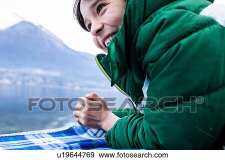 Boy in green anorak lying on picnic blanket by lakeside, cropped, Lake Como, Onno, Lombardy, Italy View Large Photo Image Stock Photo - Boy in green anorak lying on picnic blanket by lakeside, cropped, Lake Como, Onno, Lombardy, Italy. Fotosearch