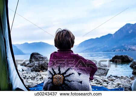 Boy looking out over lake from tent, rear view, Lake Como, Onno, Lombardy, Italy View Large Photo Image Stock Photo - Boy looking out over lake from tent, rear view, Lake Como, Onno, Lombardy, Italy. Fotosearch