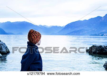 Boy looking out to lake, Onno, Lombardy, Italy View Large Photo Image Picture - Boy looking out to lake, Onno, Lombardy, Italy. Fotosearch