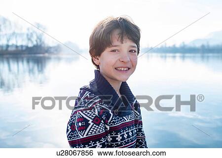 Boy on lakeside, portrait, Lake Como, Lecco, Lombardy, Italy View Large Photo Image Stock Photograph - Boy on lakeside, portrait, Lake Como, Lecco, Lombardy, Italy. Fotosearch