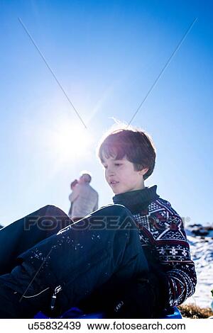 Stock Photo - Boy playing in snow, Piani Resinelli, Lombardy, Italy. Fotosearch