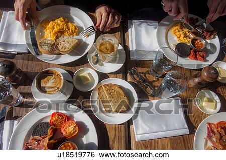 Breakfast for four outdoors on sunny day View Large Photo Image Stock Photograph - Breakfast for four outdoors on sunny day. Fotosearch